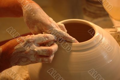 Potter`s hands creating new ceramic vase