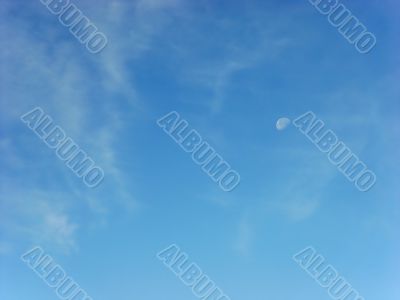 day skies with white moon and clouds