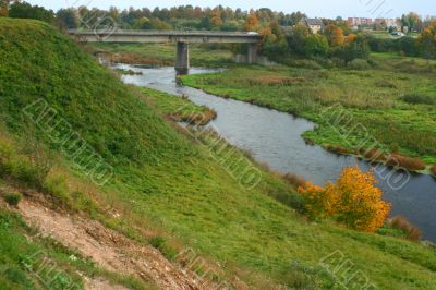 Bridge over river with hills and houses