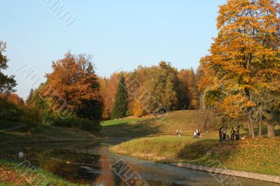 Picturesque autumn landscape of river and bright trees and bushes