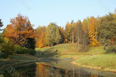 Picturesque autumn landscape of river and bright trees and bushes