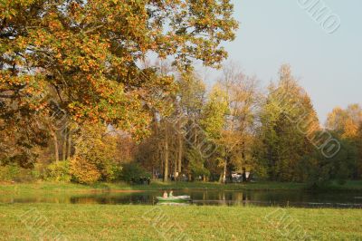 Picturesque autumn landscape of river and bright trees and bushes