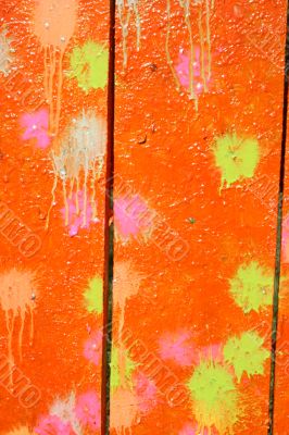 Multicolored blots and stains on wooden surface