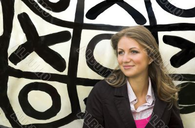  the girl on a background of game in tic-tac-toe