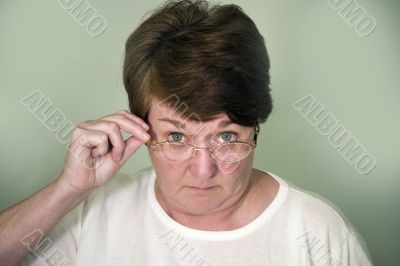 Woman looking over glasses