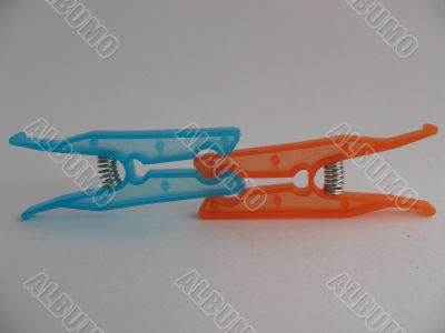 Blue and orange clothes-pegs