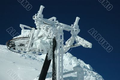 An old ski lift covered with fresh snow