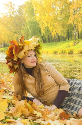 Portrait of the girl in a wreath from maple leaves