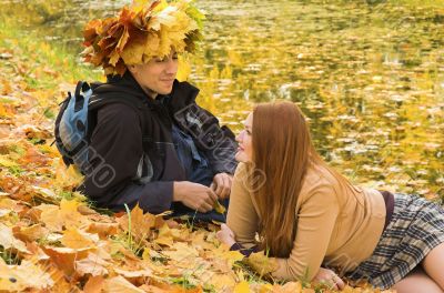 The man and the woman have a rest in autumn park