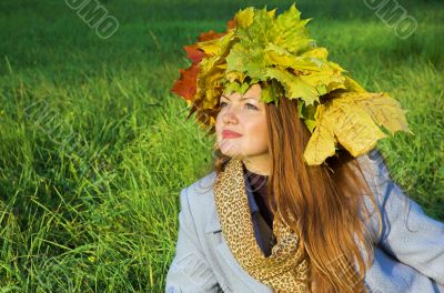 Portrait of the girl in a wreath from maple leaves
