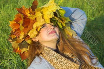 Portrait of the girl in a wreath from maple leaves