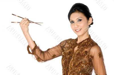 Beautiful asian girl playing with chopsticks