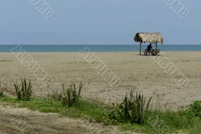 indian woman in a hut on pacific ocean