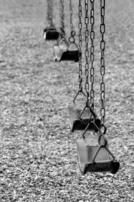 playground swings in black and white