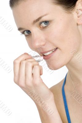 beautiful girl applying lipstick