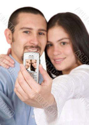 casual couple taking a pic with their mobile