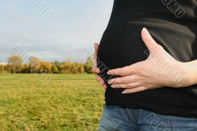 Stomach of pregnant woman with her hands