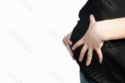 Stomach of pregnant woman with her hands on white background
