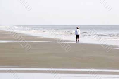 Woman Walking on Beach - Horizontal