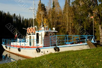 Yacht moored to coast. An autumn landscape.