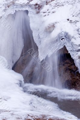 Small Waterfall Flowing Under Ice