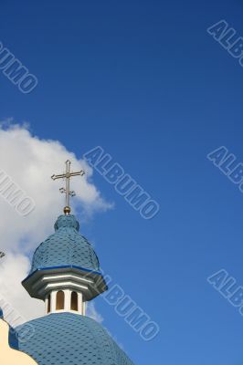 Blue cloudy sky with with blue church cupola