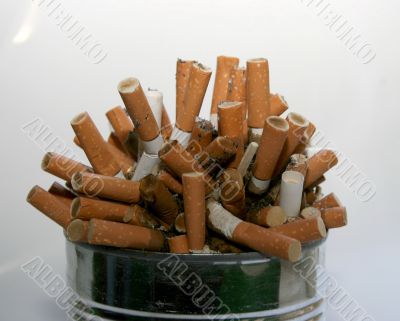 Pile of cigarette butts in ashtray