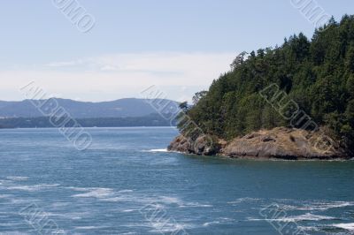 Rocky wooded coastline.