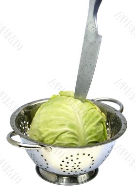 Cabbage, colander, knife on white isolated.