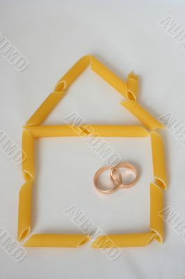 Home contour made from pasta with two wedding rings