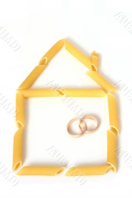 Home contour made from pasta with two wedding rings