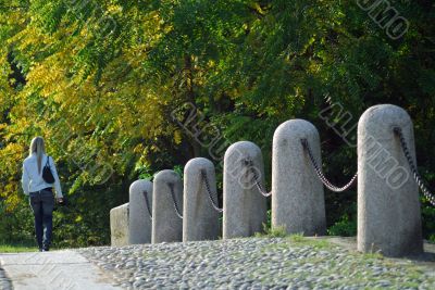 A girl on the bridge with her little dog