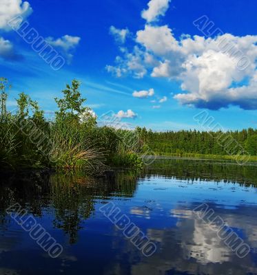 evening lake, clouds are reflected in water