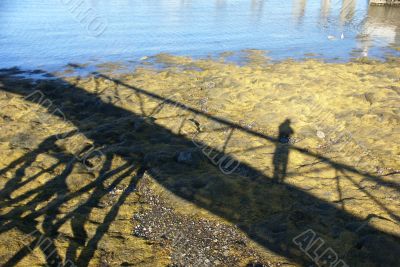 Low tide, shadows of pier