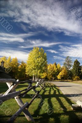 Autumn road and rail fence