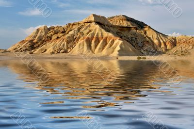 Hill reflected in the water