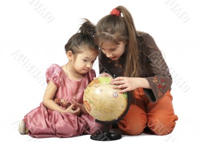 Two girls consider globe