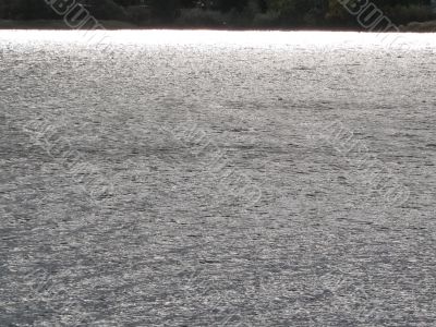 a sun reflecting in the waters of river