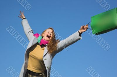 The woman with purchases on a background of the