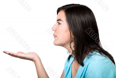 beautiful girl blowing something on her hand