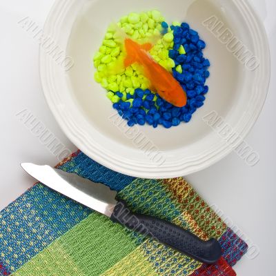 Fish on dish and knife Fish on dish and knife