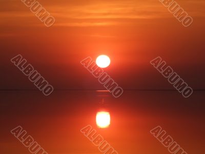 Red sunset above a serene gulf