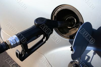 filling up auto tank at gas station