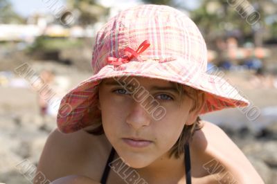 teenage girl in the hat on the beach