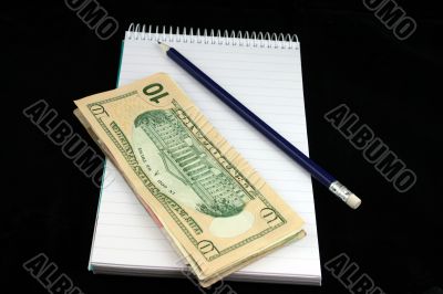 Notepad Pencil and Money