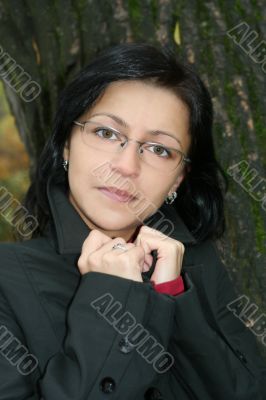 young woman with black hair in glasses, autumn shot