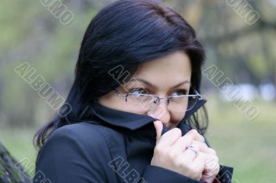 young woman with black hair in glasses, autumn shot