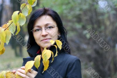 young woman with black hair in glasses, autumn shot