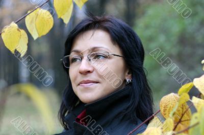 young woman with black hair in glasses, autumn shot