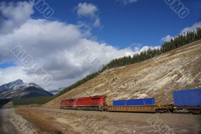 Freight train hauling up the Rocky Mountains Freight train hauling up the Rocky Mountains